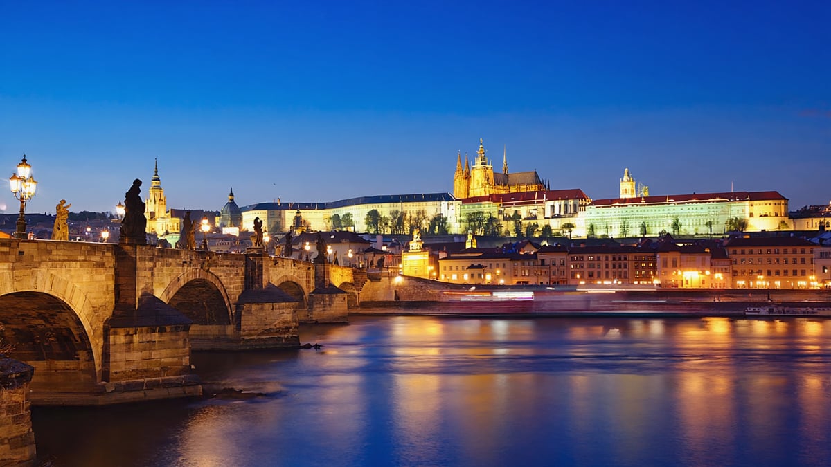 Vltava River with Charles Bridge statues at dusk